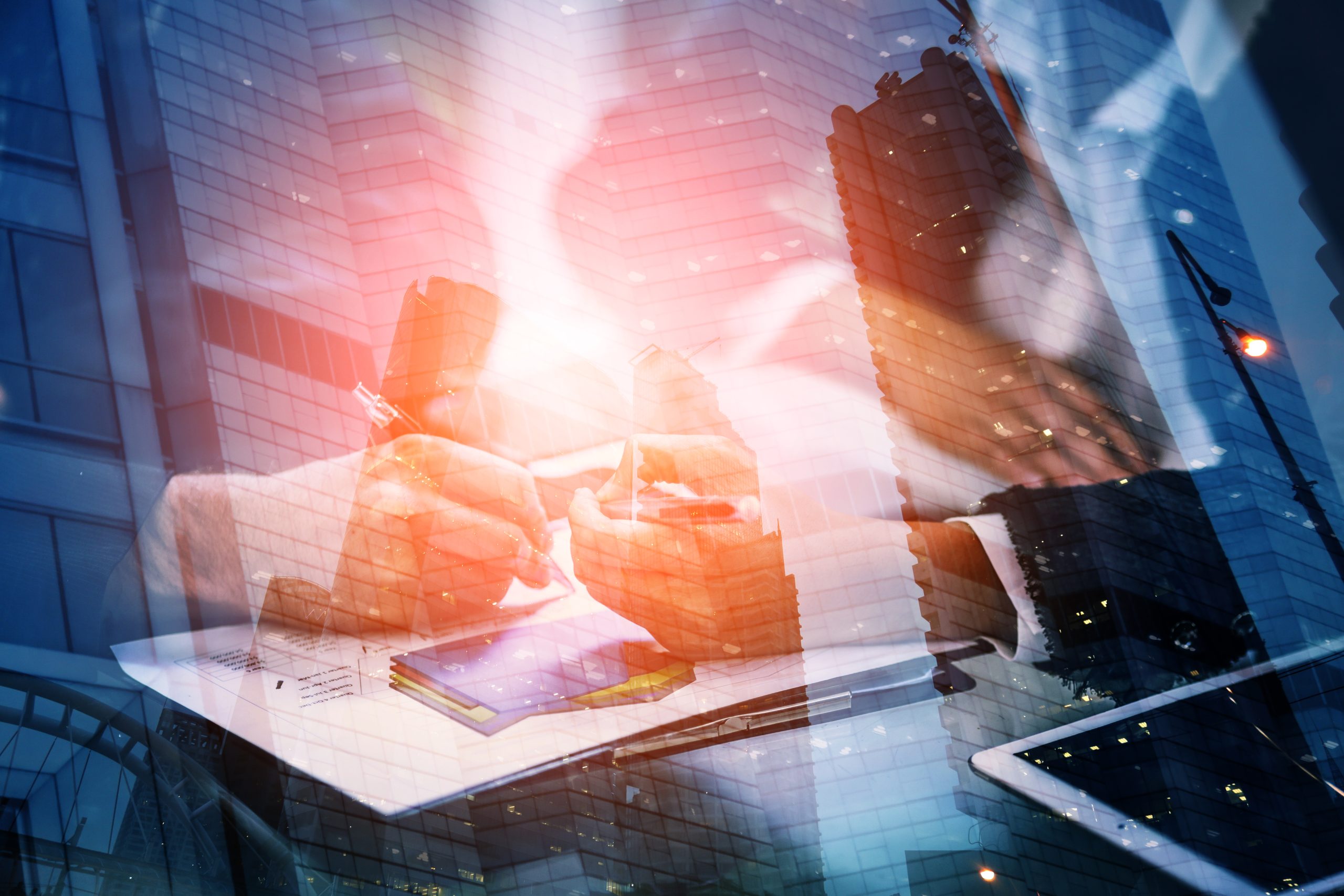 Young businessman and woman signing a paper in office. The concept of a successful business.